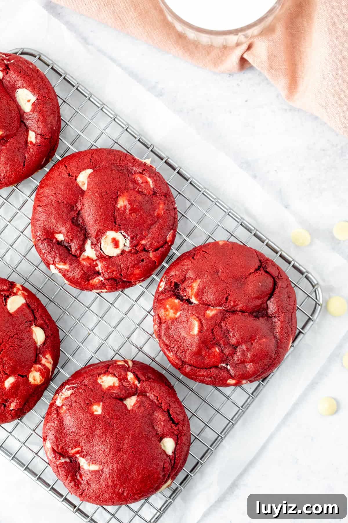 Bakery-Style Extra-Thick Red Velvet Cookies 3 red velvet cookies on a cooling rack