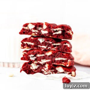 Bakery-Style Extra-Thick Red Velvet Cookies 6 bakery style red velvet cookies, broken in half and stack on top of one another