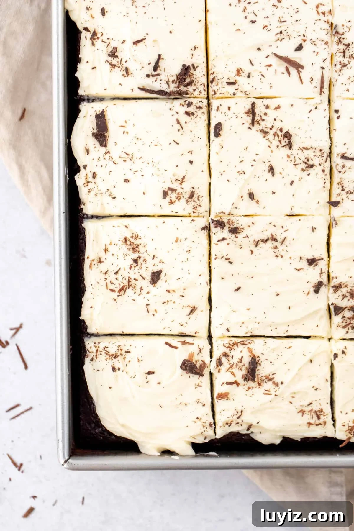 Decadent Chocolate Cake with Silky White Chocolate Frosting 4 Sheet pan of chocolate cake with white chocolate frosting and chocolate shavings on top
