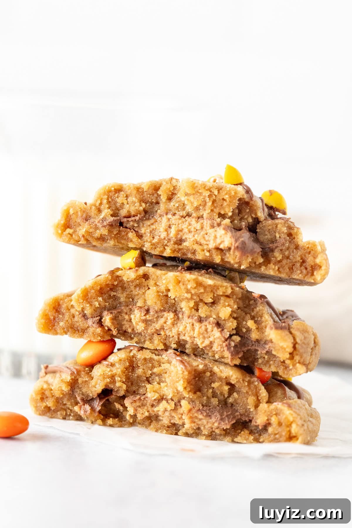 Peanut Butter Cookies Stuffed with Reese’s Cups 2 Stack of Reese's stuffed peanut butter cookies, broken in half
