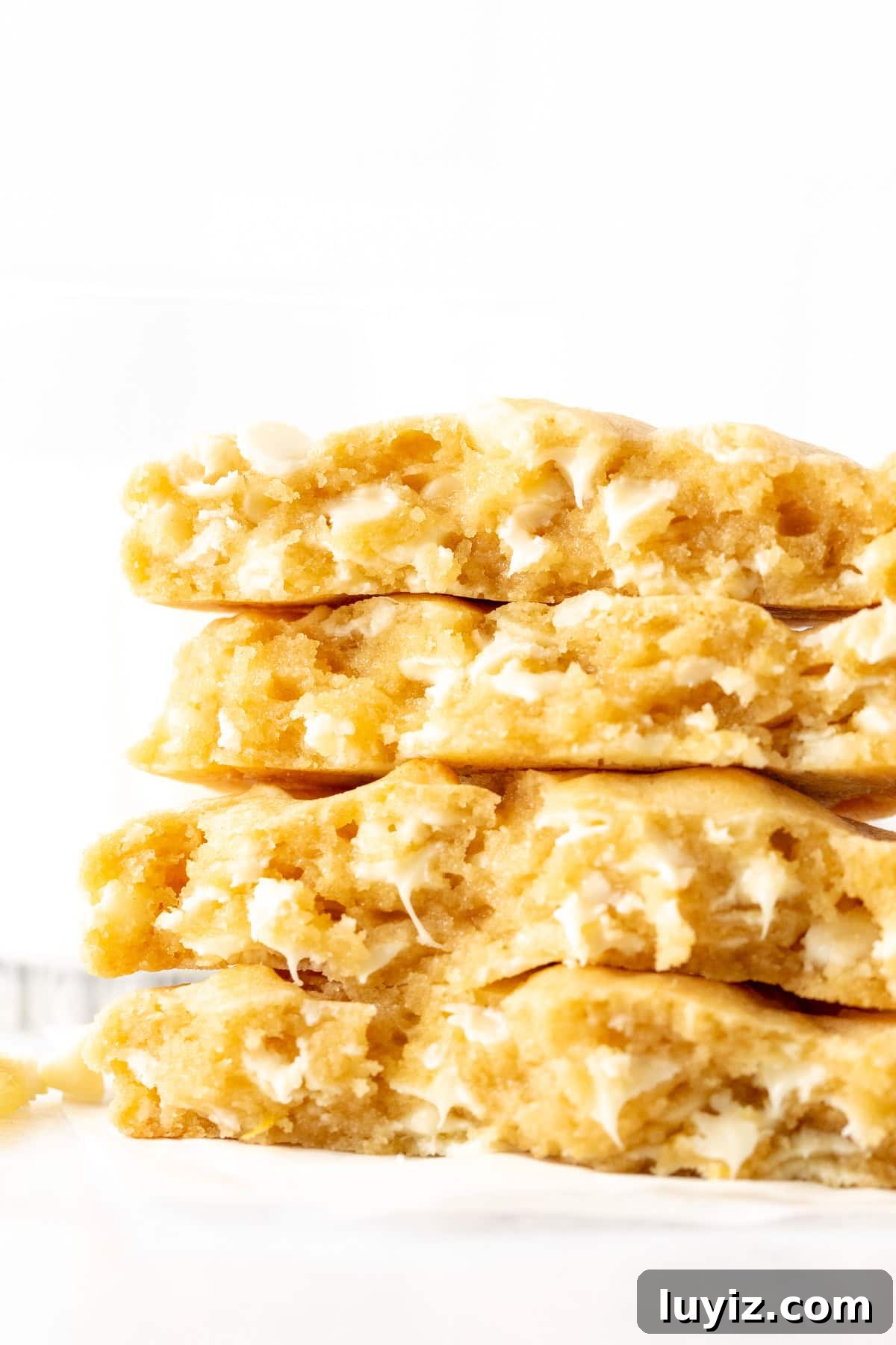 Lemon White Chocolate Chip Cookie Recipe for Tender, Zesty Bites 2 Lemon white chocolate chip cookies, broken in half and stacked on top of one another