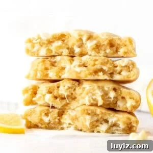 Lemon White Chocolate Chip Cookie Recipe for Tender, Zesty Bites 6 lemon white chocolate chip cookies, broken in half and stacked on top of one another
