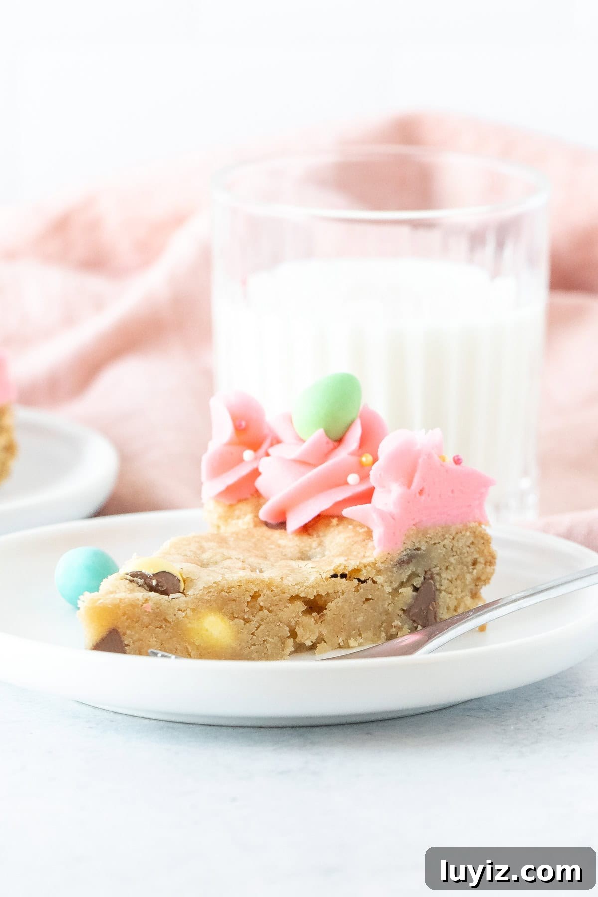 Easter Cookie Cake Recipe: Festive Cookie Cake for Spring Celebrations 6 Slice of cookie cake made with Easter chocolate and decorated with pink frosting around the edges