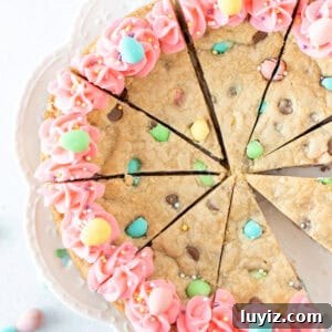 Easter Cookie Cake Recipe: Festive Cookie Cake for Spring Celebrations 7 Easter cookie cake decorated with pink frosting, cut into slices
