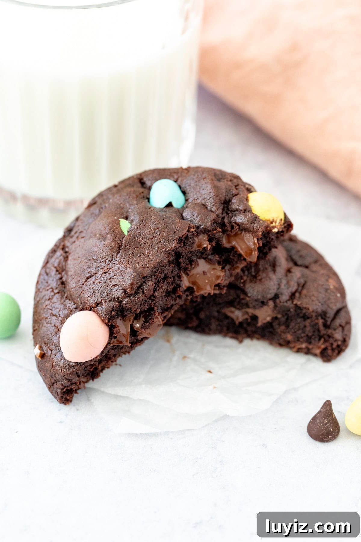 Mini Egg Chocolate Cookie Recipe: Soft Cookies with Candy Eggs 5 Chocolate mini egg cookie, broken in half with glass of milk