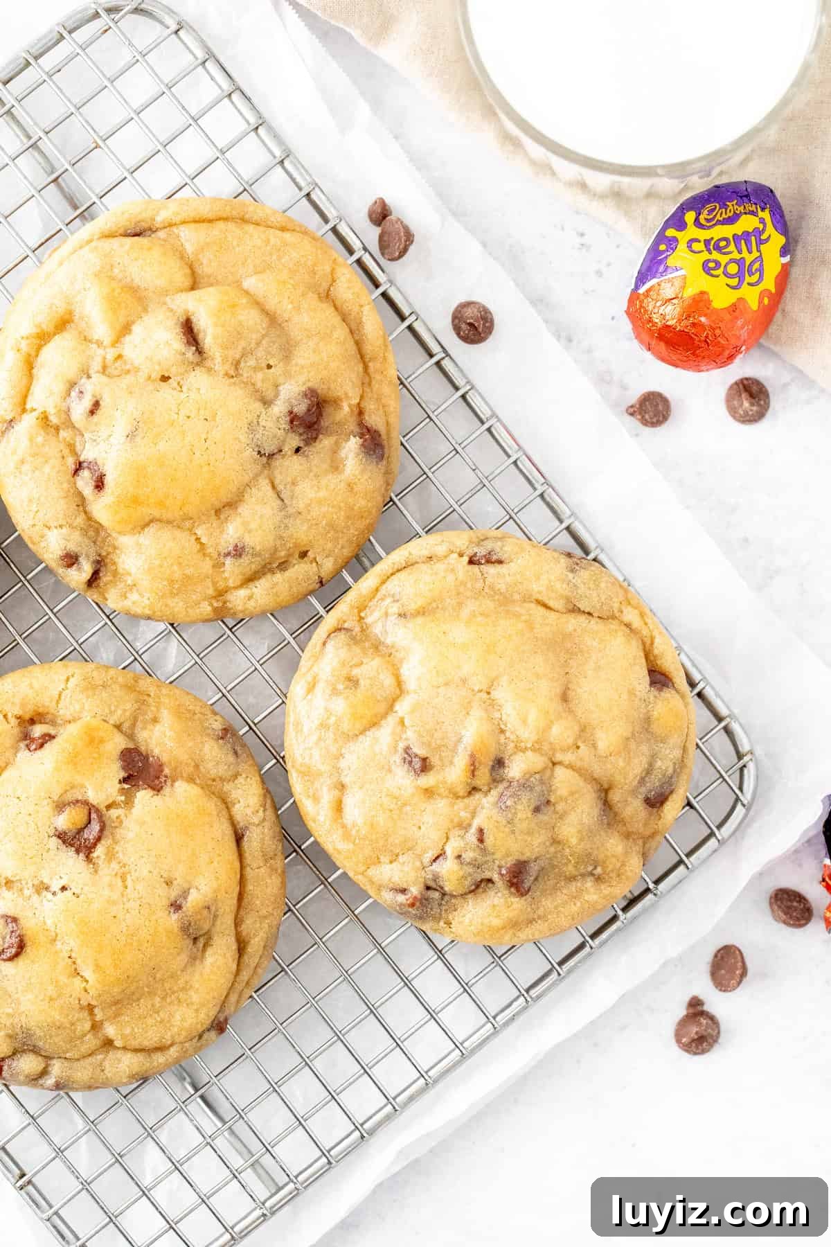 Cream Egg-Stuffed Cookies: Gooey Chocolate and Cream Filling Recipe 3 Chocolate chip cookies, stuffed with an Easter egg on a cooling rack