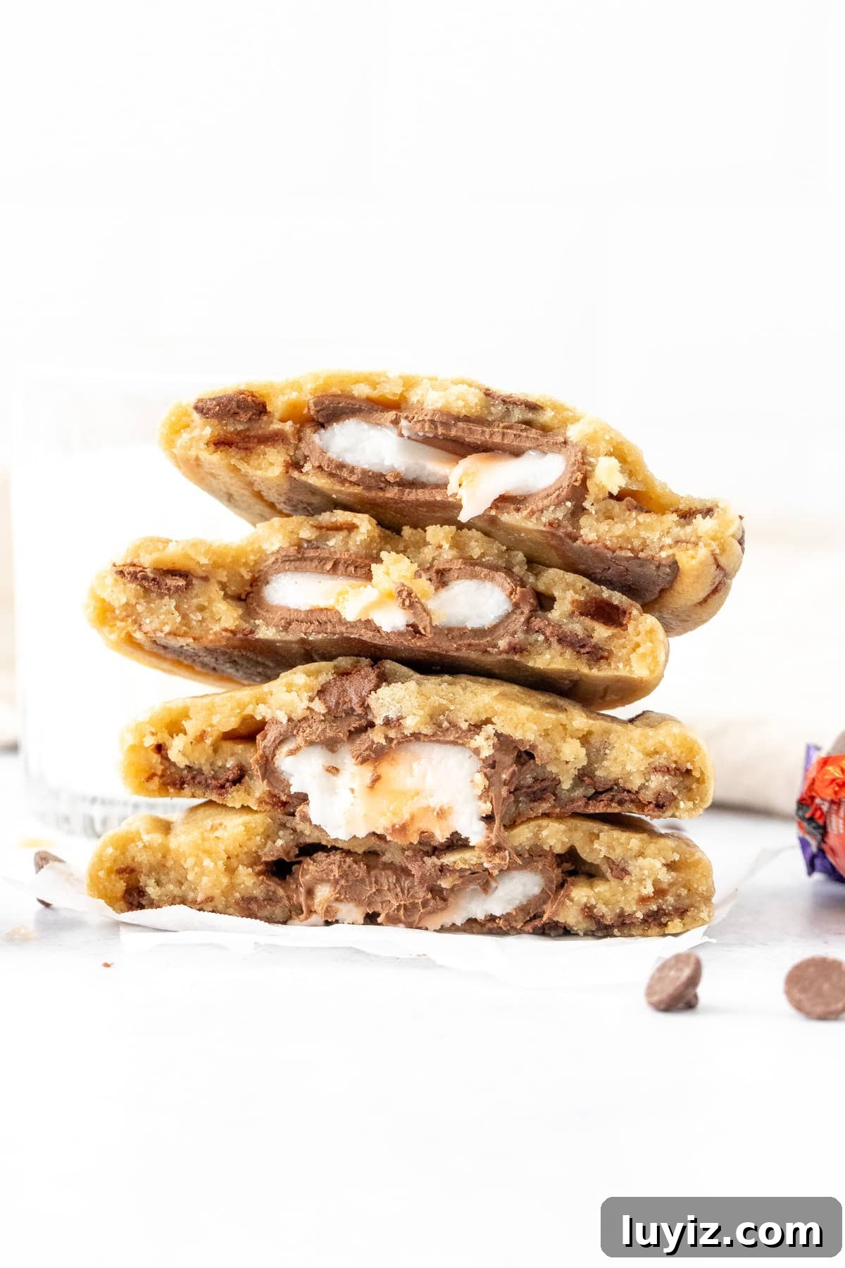 Cream Egg-Stuffed Cookies: Gooey Chocolate and Cream Filling Recipe 7 Stack of Cadbury Cream Egg stuffed chocolate chip cookies, broken in half