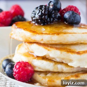 The softest, most fluffy Buttermilk Pancakes imaginable. Perfectly golden edges & designed for soaking up lots of maple syrup - these are the BEST pancakes you'll ever eat!