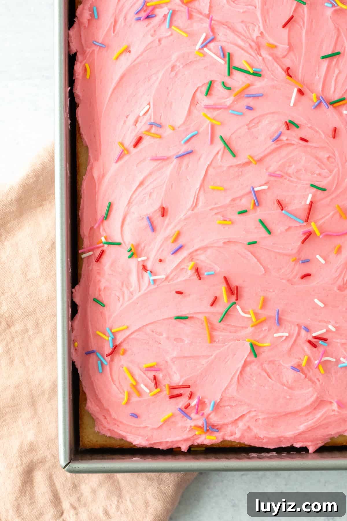 Classic Moist Vanilla Sheet Cake Recipe for Parties and Potlucks 3 9x13 inch pan of vanilla sheet cake with pink frosting