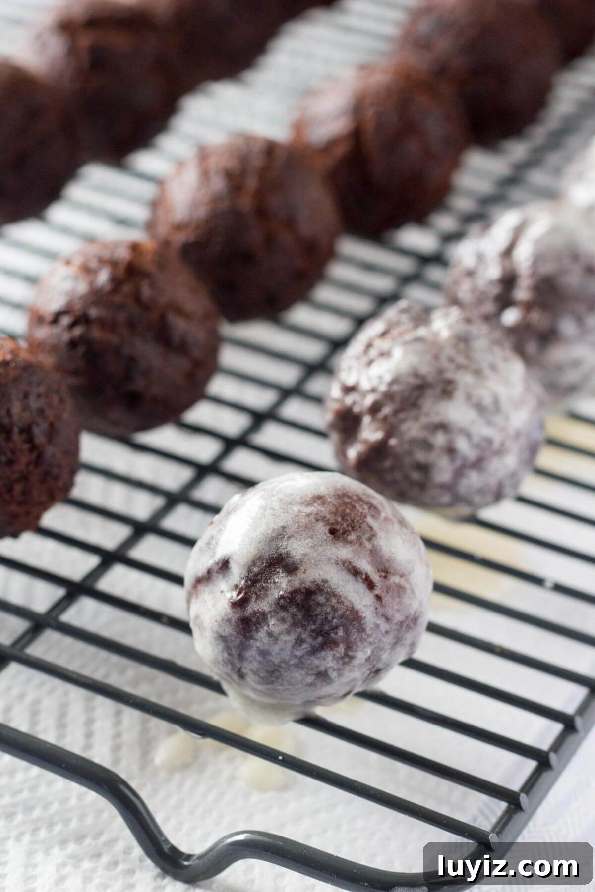 Chocolate Doughnut Holes: Bite-Sized Chocolate Donut Bites Recipe 4 Perfectly fudgy Chocolate Doughnut Holes dipped in sweet vanilla glaze! Fluffy, oh so moist & so much better than the doughnut shop! www.justsotasty.com