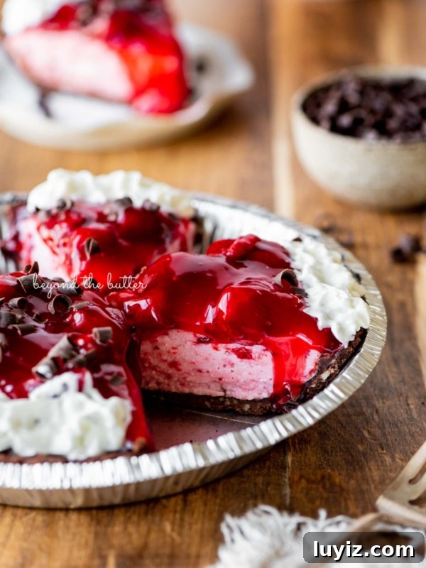 Decadent No-Bake Dark Chocolate Tart Recipe 5 Sliced no bake strawberry chocolate cream pie on wood table