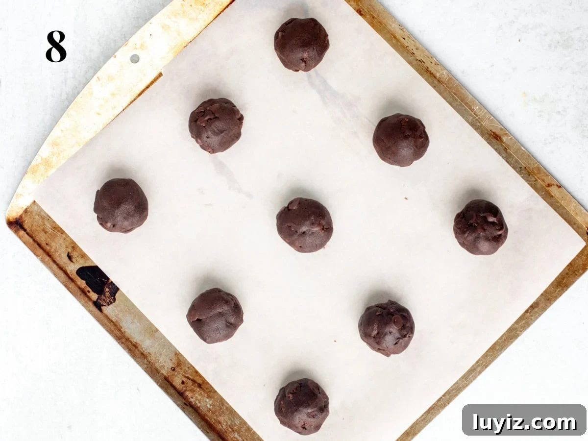 Chewy Nutella Cookies Recipe: Rich, Melt-in-Your-Mouth Treats 6 Lined cookie sheet with Nutella cookie dough balls
