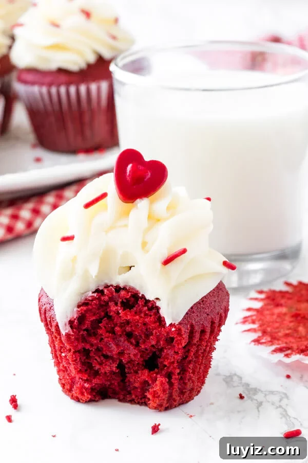 Decadent Red Velvet Cupcakes with Cream Cheese Frosting 6 Red velvet cupcake with cream cheese frosting and a bite taken out of it. Simply the best red velvet cupcake recipe.