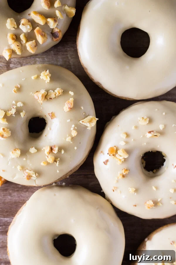 Spiced Maple Doughnuts Recipe with Warm Autumn Flavors 3 A delicious spice cake doughnut with sweet maple glaze and topped with crushed walnuts. It's like fall in maple doughnut form - and best of all, they're baked instead of fried!