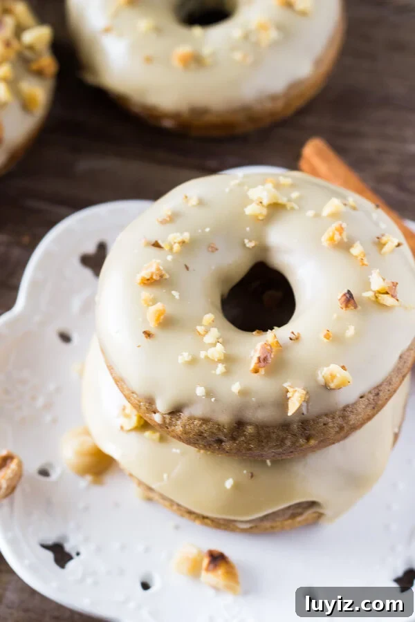 Spiced Maple Doughnuts Recipe with Warm Autumn Flavors 5 A delicious spice cake doughnut with sweet maple glaze and topped with crushed walnuts. It's like fall in maple doughnut form - and best of all, they're baked instead of fried!