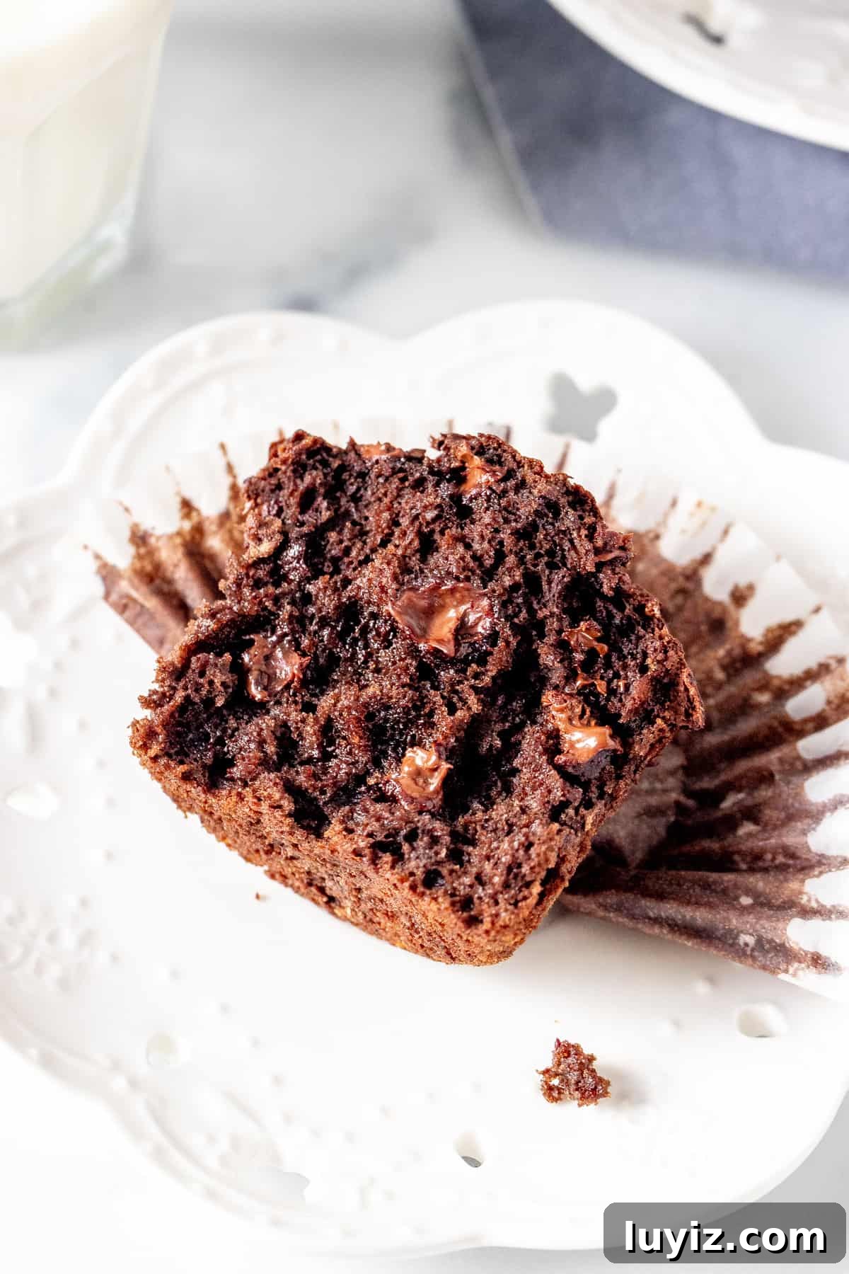 Double Chocolate Banana Muffins with Rich Cocoa Swirl 2 Half of a banana chocolate muffin on a plate