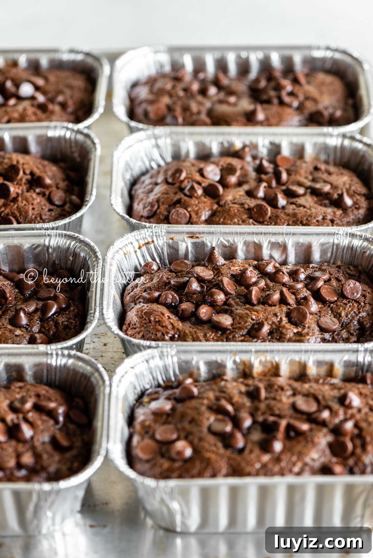 One-Bowl Chocolate Zucchini Quick Bread Recipe 8 Angled image of mini chocolate zucchini bread loaves | All Images © Beyond the Butter™