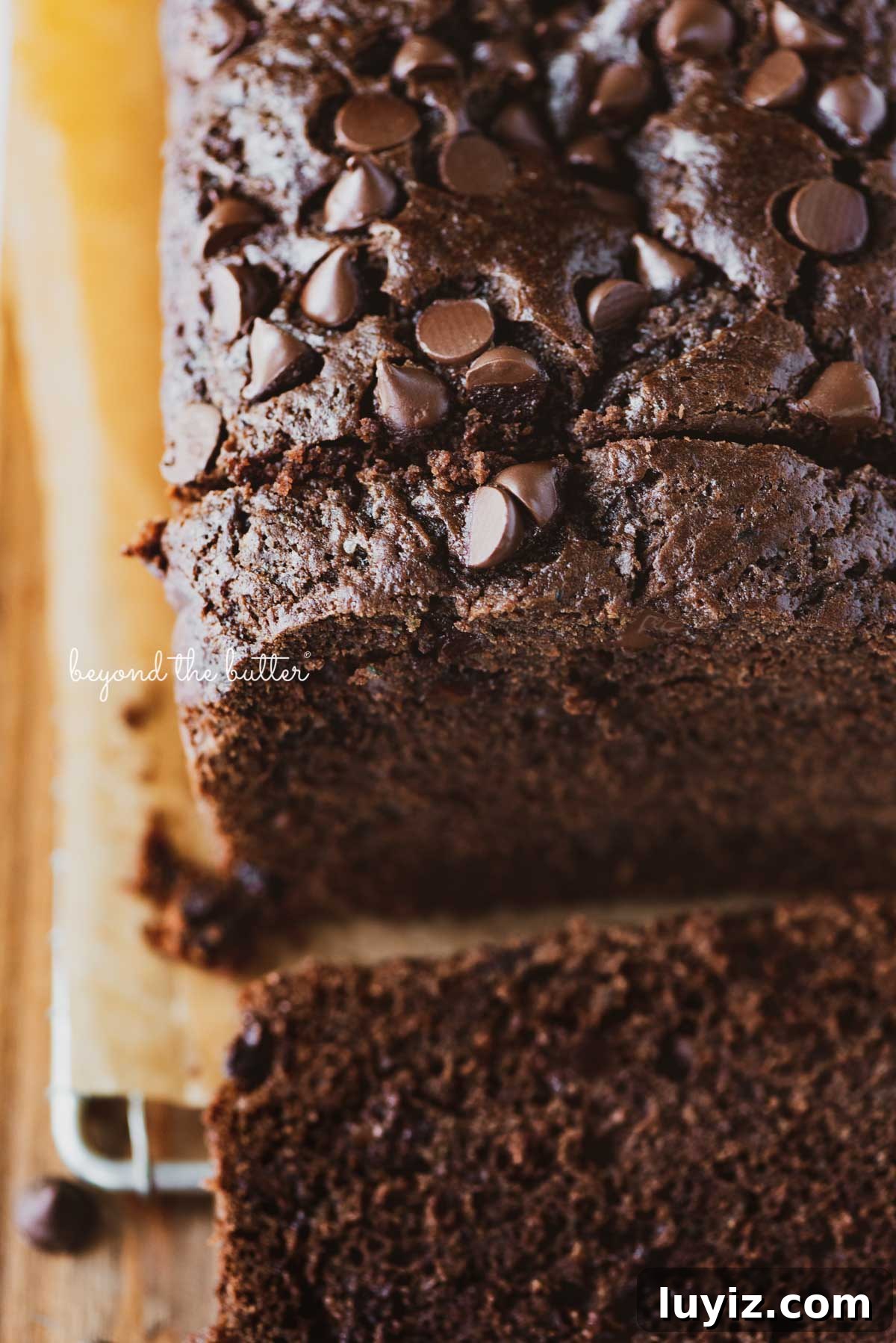 One-Bowl Chocolate Zucchini Quick Bread Recipe 10 Sliced chocolate zucchini bread on a cutting board | © Beyond the Butter®