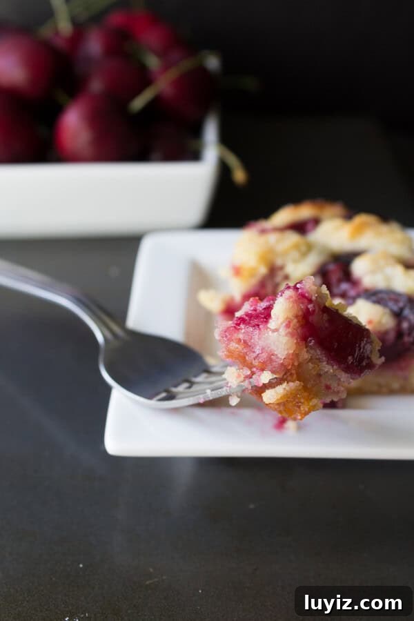 Cherry Almond Bars Recipe with Homemade Cherry Filling 3 Cherry Almond Bars- in between a pie bar & a crumb bar, this recipe for cherry almond bars have a delicious buttery almond base and are bursting with fresh cherries | www.justsotasty.com