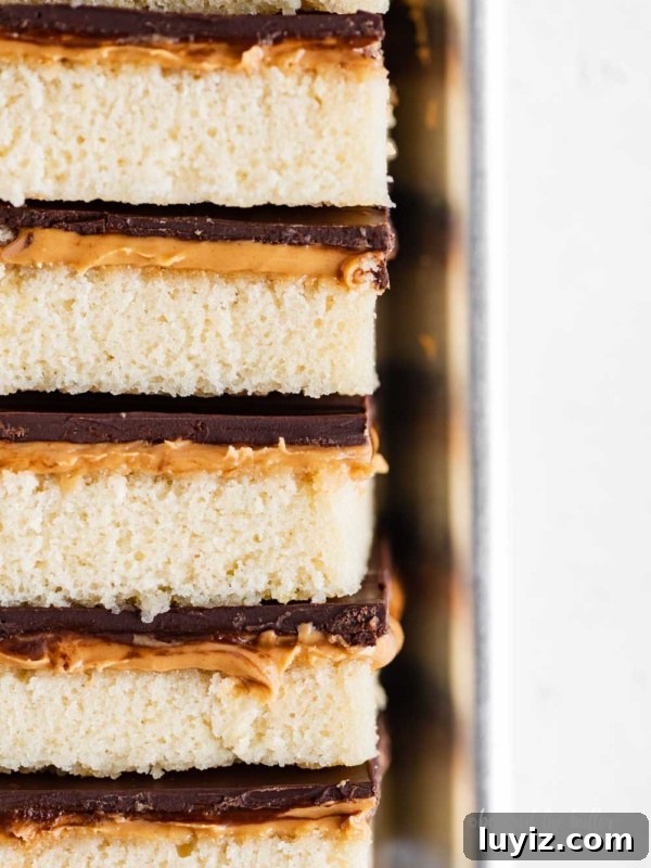 Peanut Butter Eggs Dipped in Chocolate: Homemade Candy Recipe 12 Closeup image of stacked homemade peanut butter kandy kakes on baking sheet.