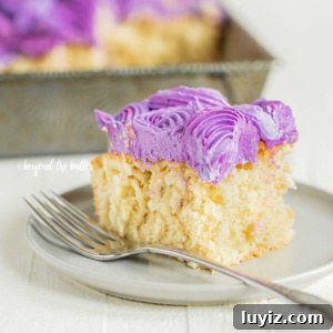 Moist Coconut Sheet Cake Recipe with Creamy Coconut Frosting 11 Slice of frosted coconut sheet cake on dessert plate with rest of sheet cake in the background.