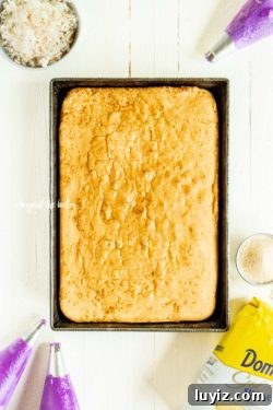 Moist Coconut Sheet Cake Recipe with Creamy Coconut Frosting 6 Coconut Sheet Cake with Coconut Buttercream Frosting | All Images © Beyond the Butter, LLC