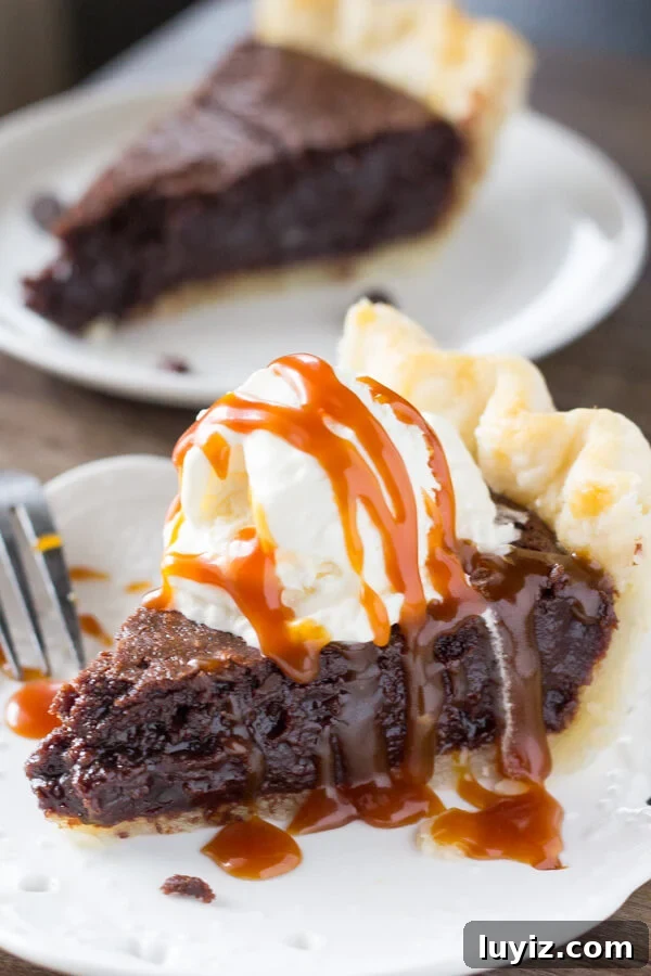 This easy, homemade Fudge Brownie Pie features a flaky, golden pie crust shell filled with the gooiest, fudgiest brownie. Serve it with ice cream & caramel sauce for the ultimate treat!