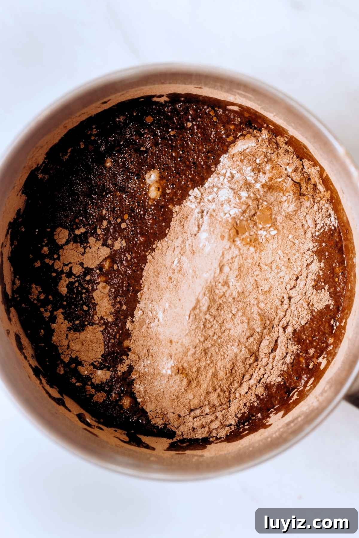 Decadent Chocolate Cake with Oreo Buttercream Frosting 10 Chocolate cake dry ingredients added to stainless steel mixing bowl with wet ingredients.