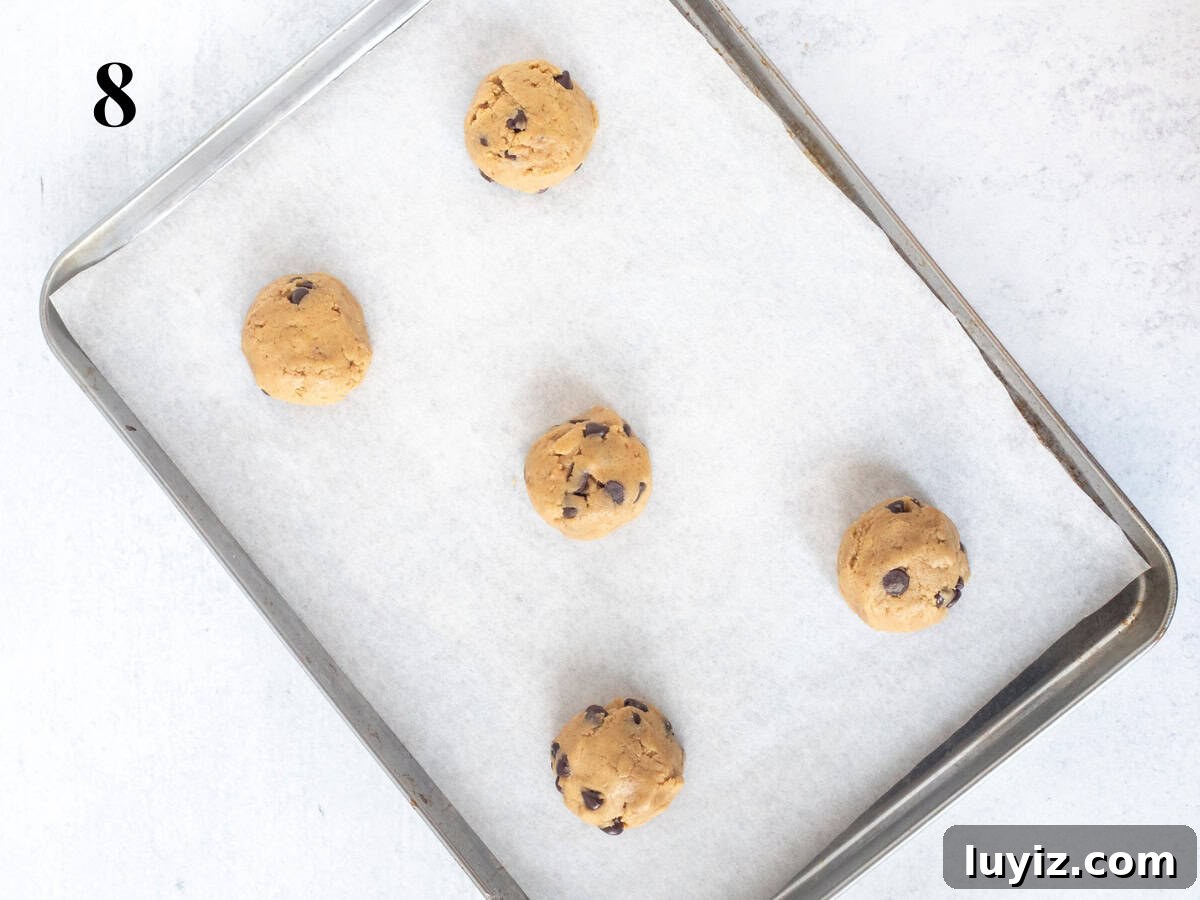 Brown Butter Toffee Chocolate Chip Cookies — Crispy & Gooey 8 Cookie tray with cookie dough balls.