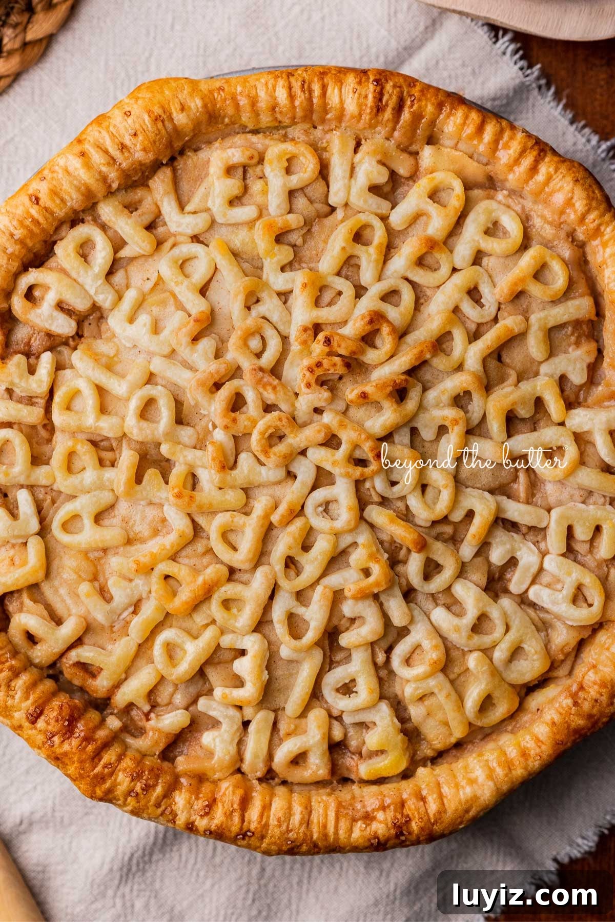 Classic Homemade Apple Pie Recipe for Perfect Crust and Filling 7 Homemade apple pie with pie crust letters spelling out apple pie in all capital letters.