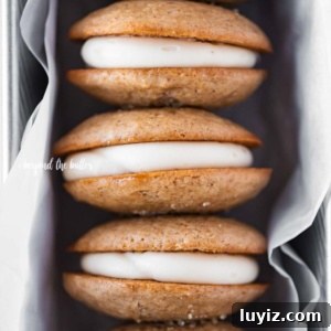 Apple Cider Whoopie Pies with Cinnamon Buttercream Filling 13 Row of apple cider whoopie pies packed in a parchment paper lined loaf pan.