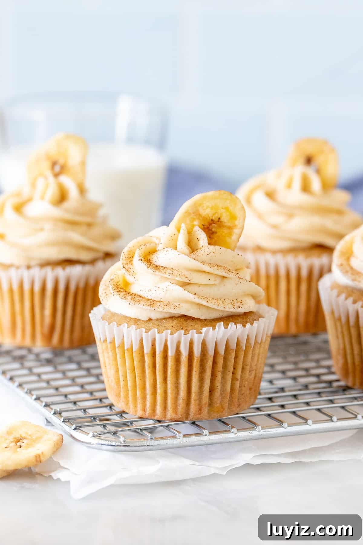 Banana Cupcakes with Cream Cheese Frosting Recipe 2 Banana cupcakes with cream cheese frosting on a cooling rack
