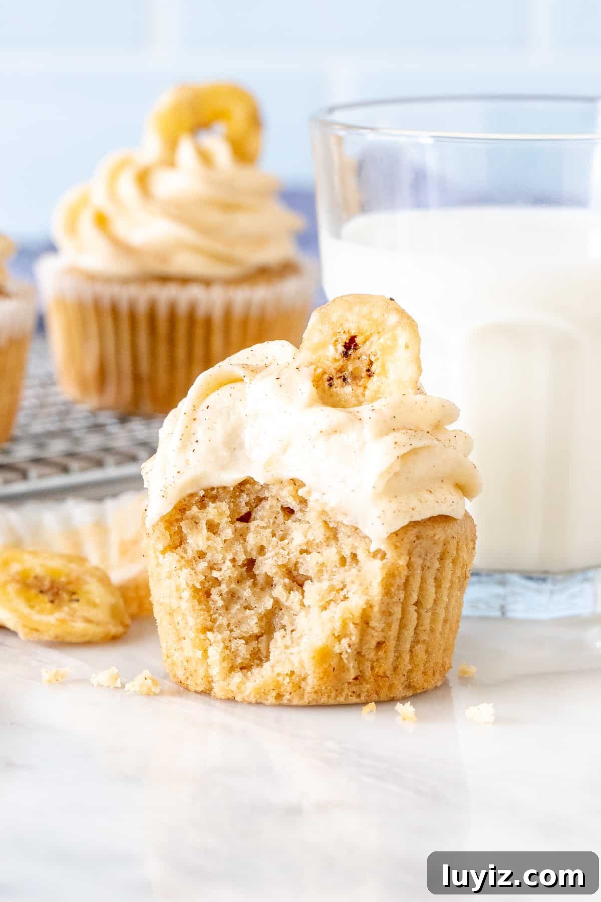 Banana Cupcakes with Cream Cheese Frosting Recipe 10 Banana bread cupcake with frosting on top with a bite taken out of it
