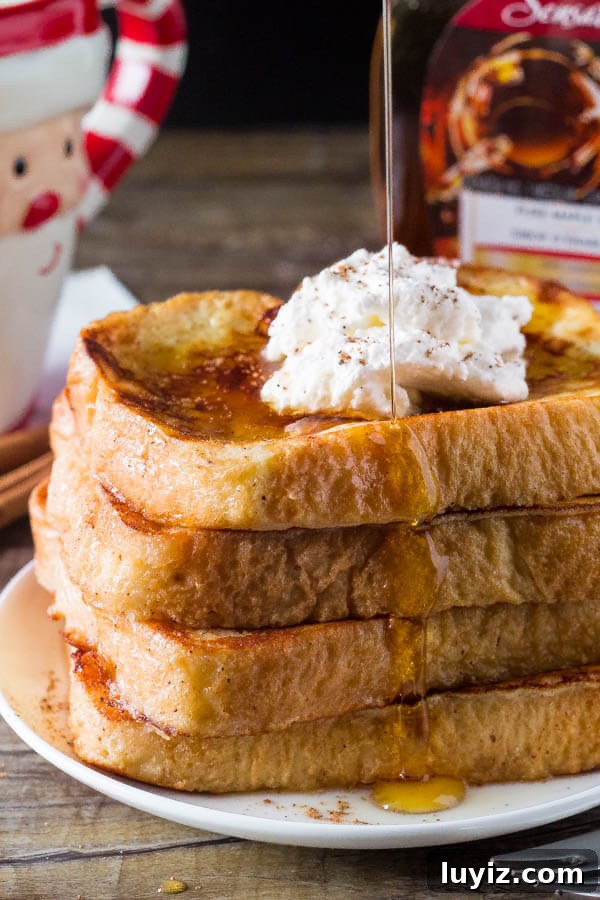 Eggnog French Toast Recipe: Festive Holiday Brunch Idea 3 Pouring maple syrup on a stack of eggnog french toast.