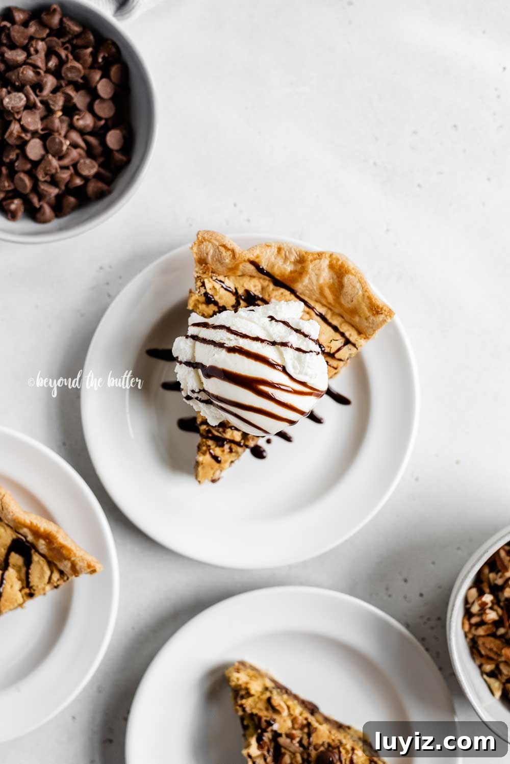 Ultimate Chocolate Chip Pie Recipe: Gooey, Crispy, and Irresistible 7 Overhead image of 3 slices of chocolate chip pie on dessert plates with one having a scoop of vanilla ice cream on top