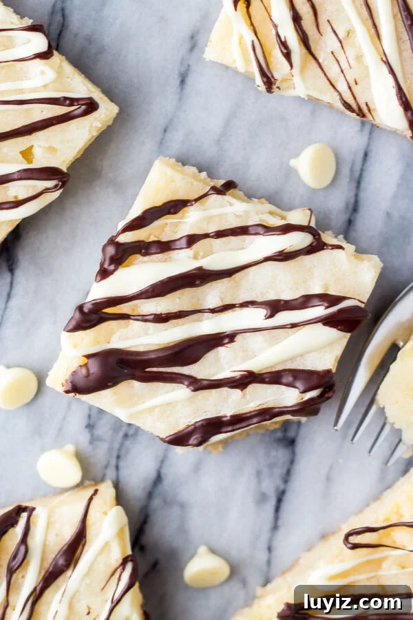 Decadent White Chocolate Brownies Recipe for Dessert Lovers 3 White Chocolate Brownies. These super fudgy, gooey white chocolate brownies are made in one bowl and perfect for white chocolate lovers. www.justsotasty.com