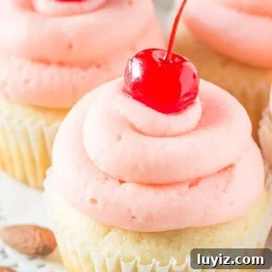 Cherry Almond Cupcakes. Fluffy, moist, super soft almond cupcakes topped with maraschino cherry frosting. www.justsotasty.com