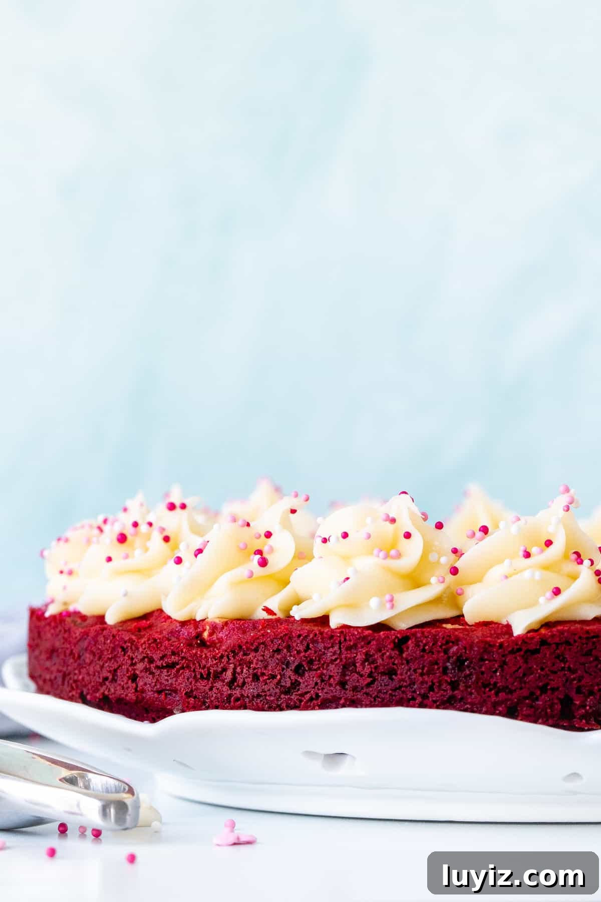 Red Velvet Cookie Cake Recipe: Decadent Layered Dessert Guide 3 9-inch round red velvet cookie cake decorated with rosettes of cream cheese frosting