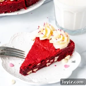 Slice of giant red velvet cookie with cream cheese icing