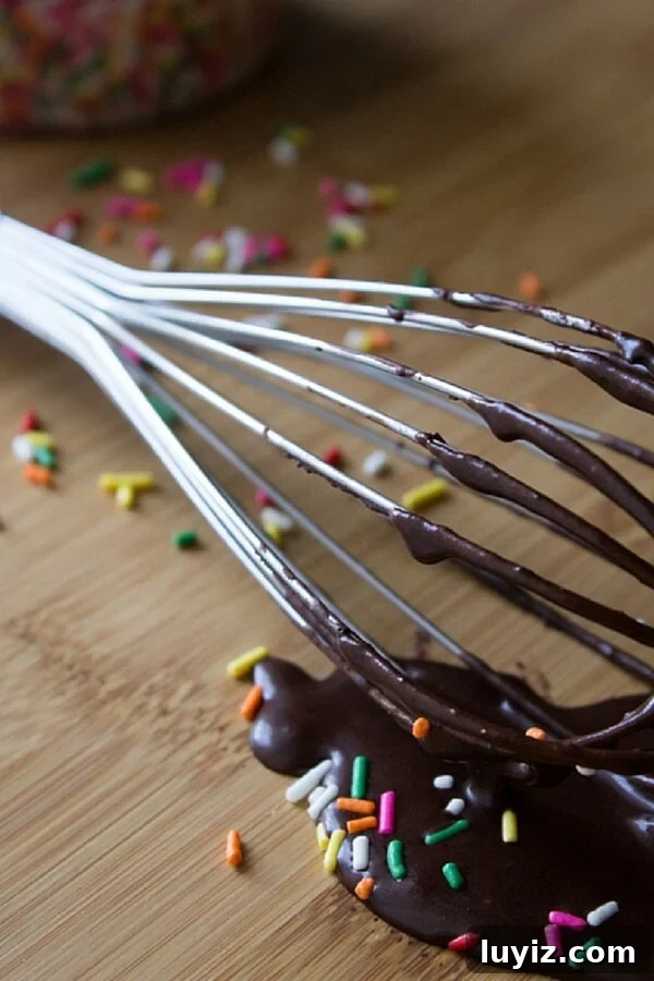 Decadent Double Chocolate Doughnuts Recipe for Chocolate Lovers 4 A whisk with chocolate glaze that's perfect for dipping chocolate doughnuts in.