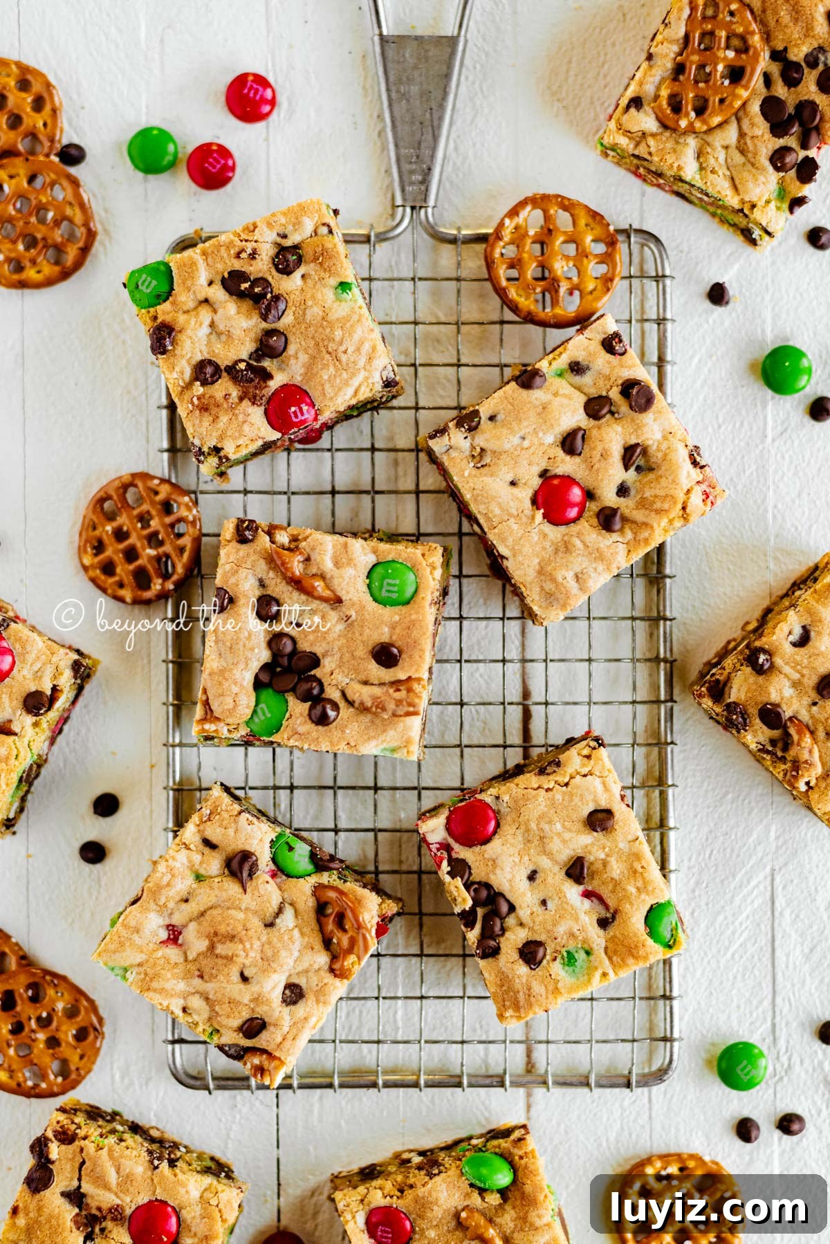 Holiday Chocolate Chip Cookie Bars for Festive Baking 5 Overhead image of holiday chocolate chip cookie bars cut and placed on top of a small cooling rack | All Images © Beyond the Butter®