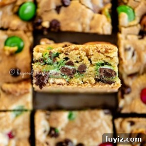Holiday Chocolate Chip Cookie Bars for Festive Baking 10 Close up image of easy holiday chocolate chip cookie bars cut into squares with center square on its side.