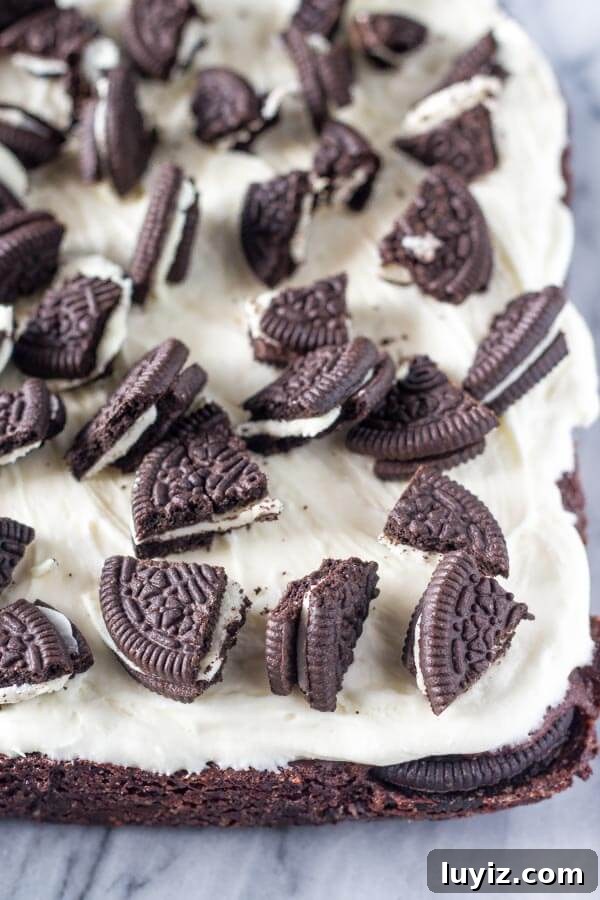 Marshmallow Oreo Brownies Recipe — Gooey Chocolate Cookie Bars 3 Marshmallow Oreo Brownies. Fudgy brownies stuffed with Oreo cookies, and topped with fluffy marshmallow frosting and more Oreo cookies. www.justsotasty.com