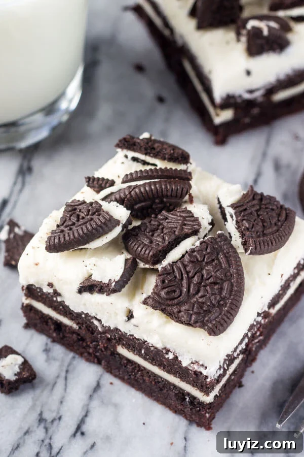 Marshmallow Oreo Brownies Recipe — Gooey Chocolate Cookie Bars 5 Marshmallow Oreo Brownies. Fudgy brownies stuffed with Oreo cookies, and topped with fluffy marshmallow frosting and more Oreo cookies. www.justsotasty.com
