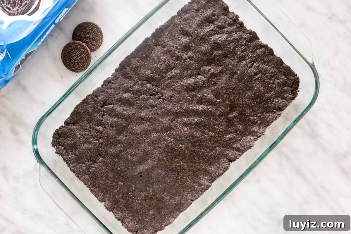 Peanut Butter Cheesecake Bars Recipe — Creamy No-Bake Dessert 3 Oreo cookie crust in a 9x13 inch pan.