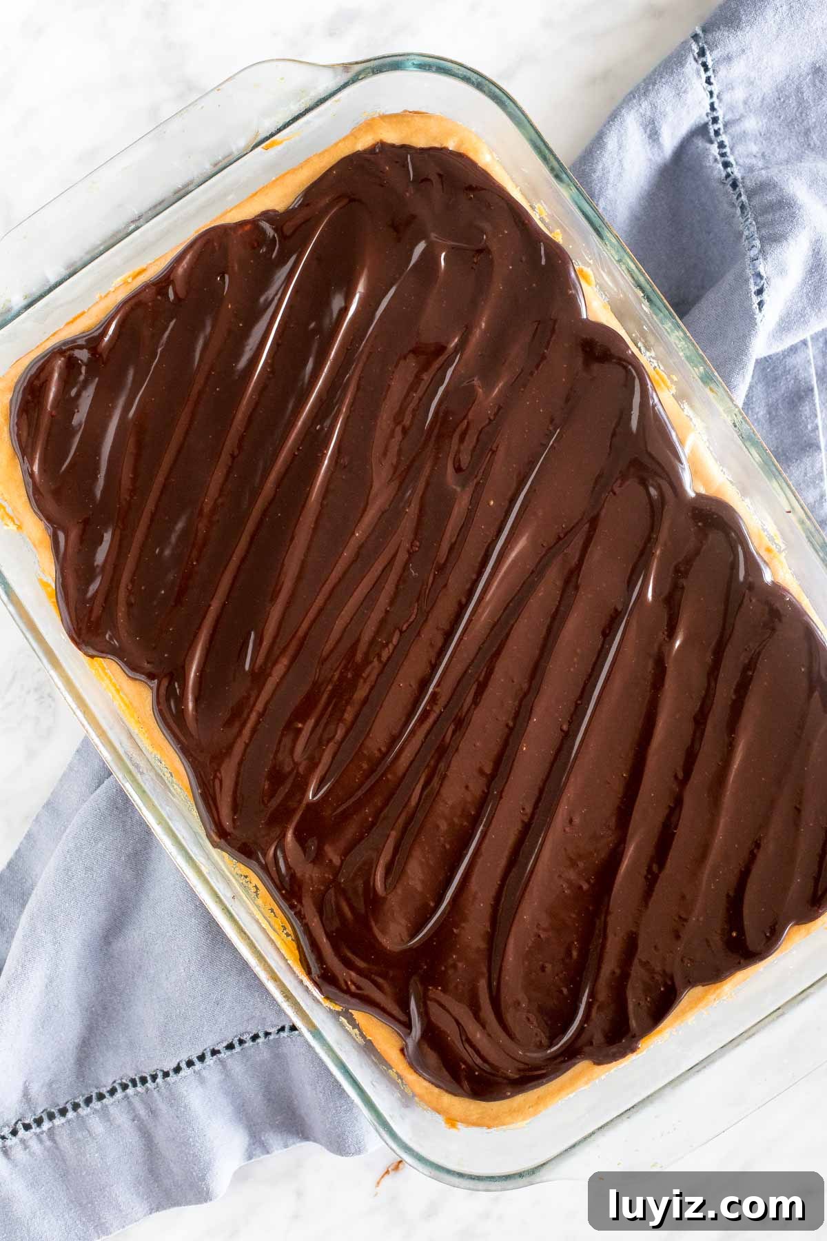 Peanut Butter Cheesecake Bars Recipe — Creamy No-Bake Dessert 5 9x13 inch pan of peanut butter chocolate cheesecake.