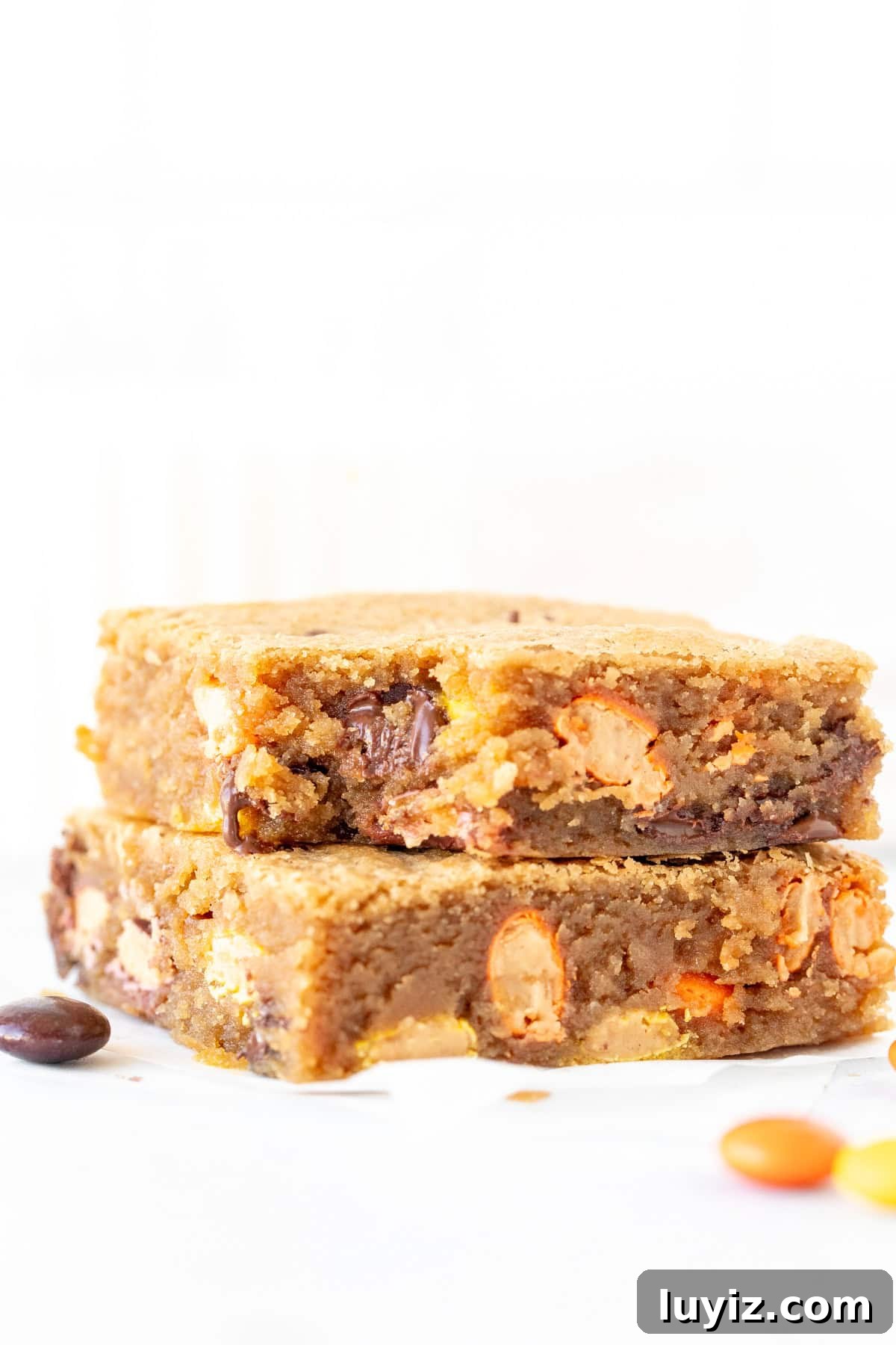 Chewy Peanut Butter Blondies with Salted Caramel Drizzle 3 2 peanut butter blondies stacked, with a bite taken out of the top blondie