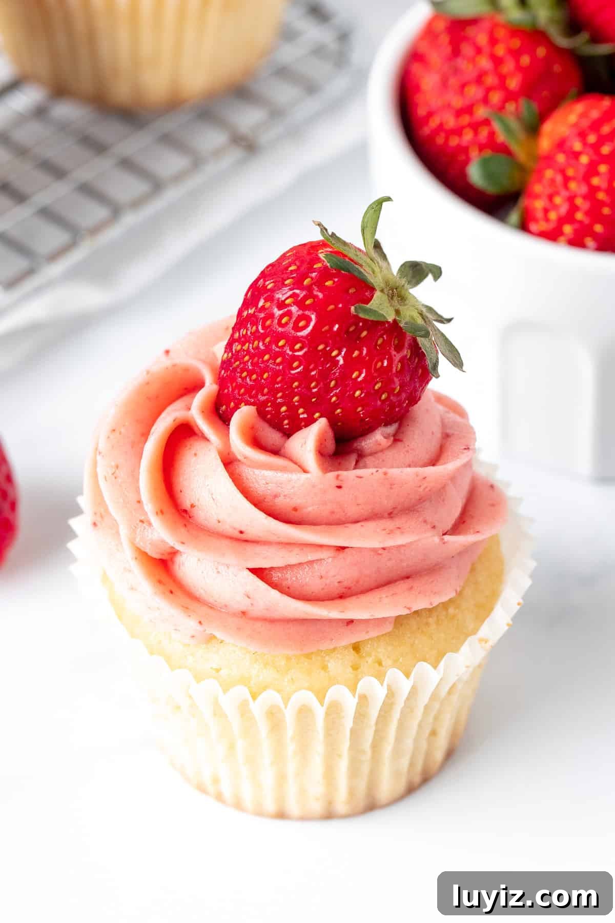 Vanilla cupcake with strawberry buttercream frosting