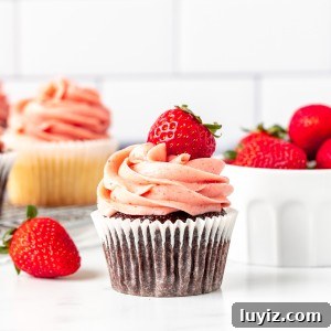 Strawberry Buttercream Frosting Made with Fresh or Frozen Berries 8 Chocolate cupcake decorated with strawberry buttercream frosting and topped with a berry