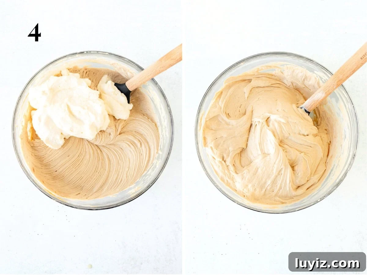 No-Bake Peanut Butter Cheesecake Recipe — Creamy No-Bake Slice 6 Whipped cream added to bowl of peanut butter cheesecake filling, bowl of no bake peanut butter cheesecake filling